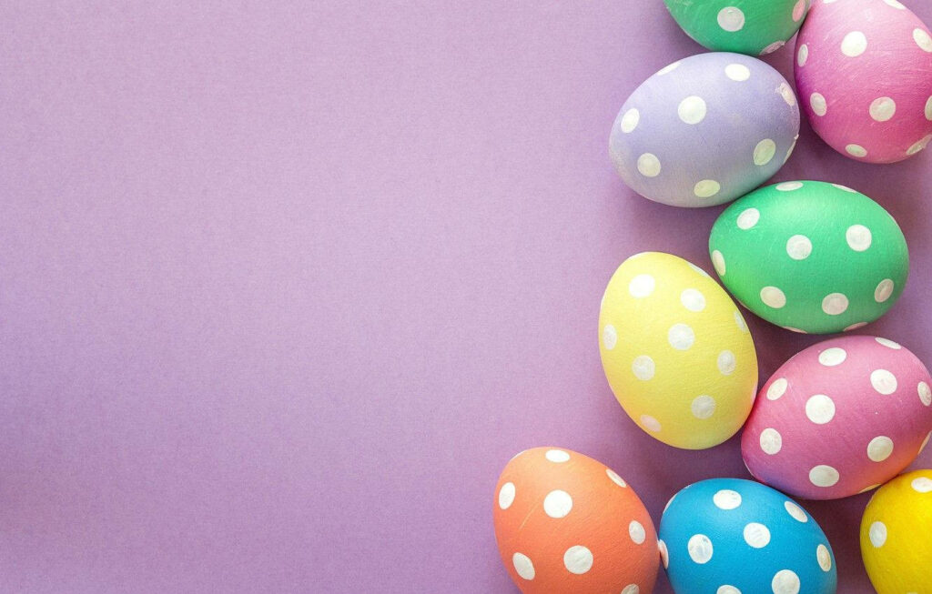 Festive Polka-Dotted Easter Eggs Wallpaper on Purple Background