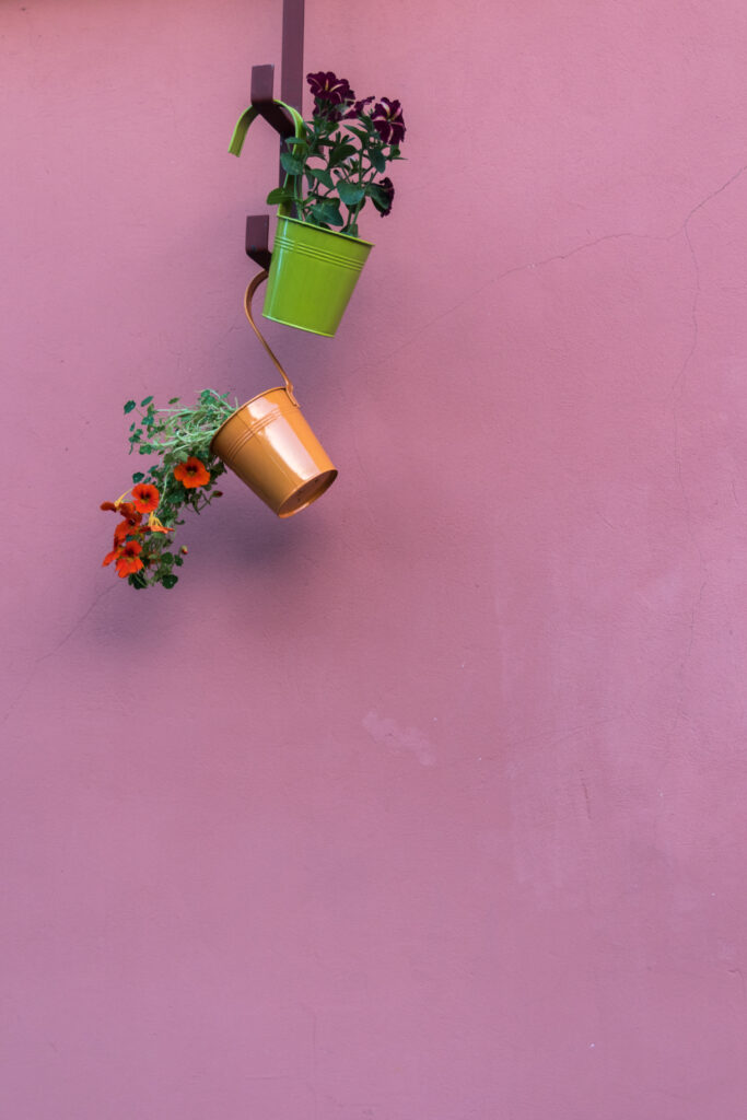 Elegant Minimalist Wallpaper: Colorful Pots on Soft Pink Background