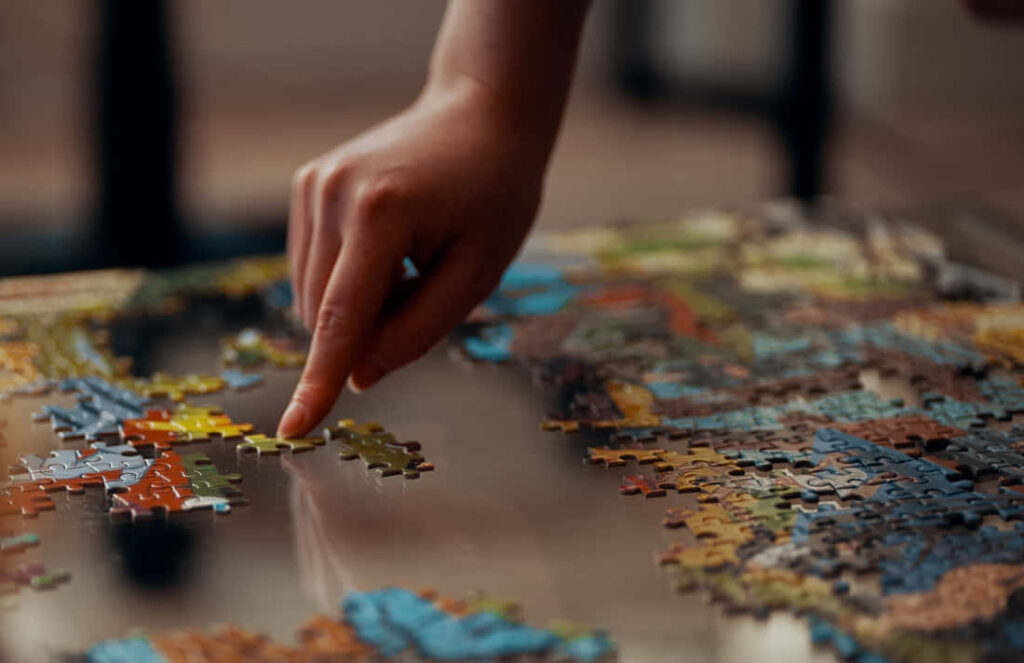 Close-Up: Colorful Puzzle Assembly on Reflective Surface - Wallpaper