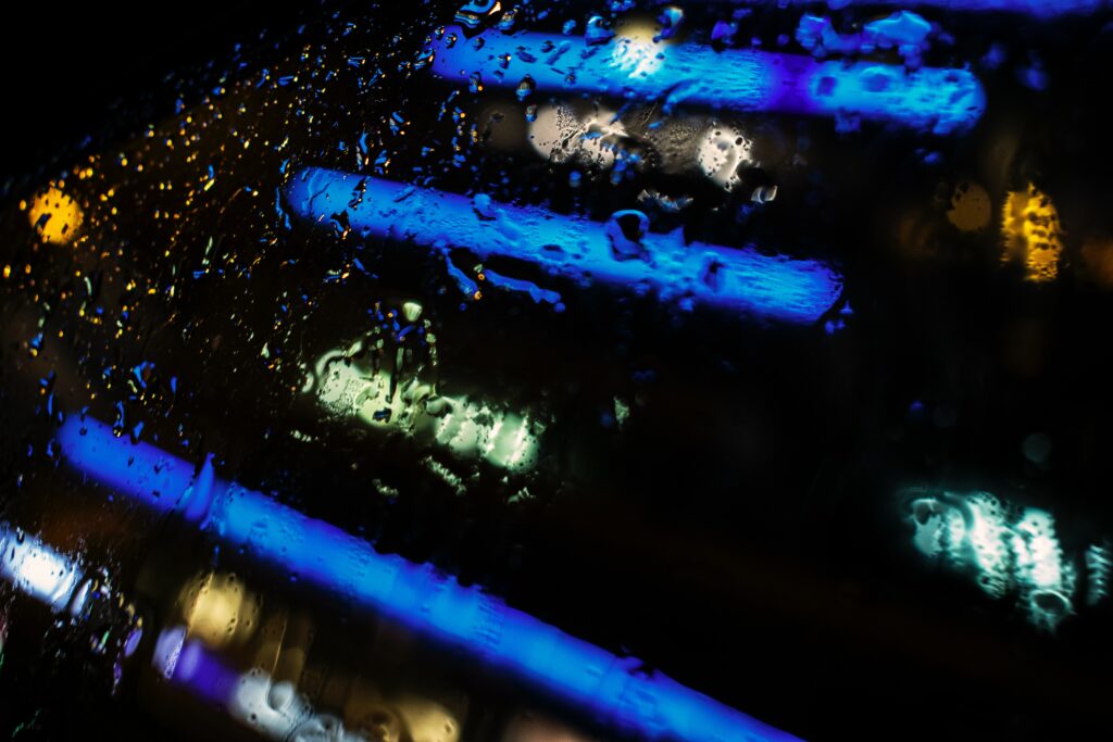 Rain Droplets on Glass: Colorful Neon Light Wallpaper Background