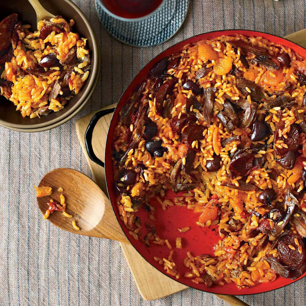 Vibrant Rice Dish with Apricots & Duck - Rustic Red Pan Wallpaper
