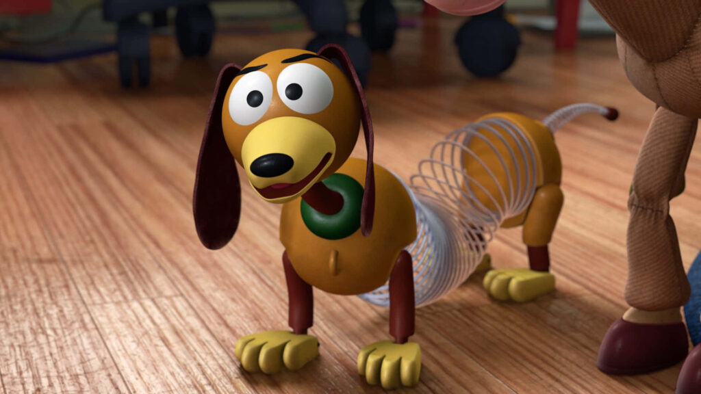 Colorful Slinky Dog Wallpaper: Toy Story's Playful Icon on Wood Floor