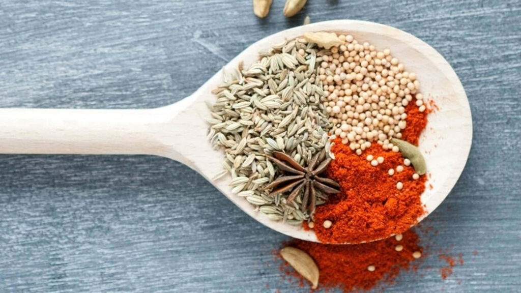 Colorful Spices on Wooden Spoon | Textured Wallpaper Background