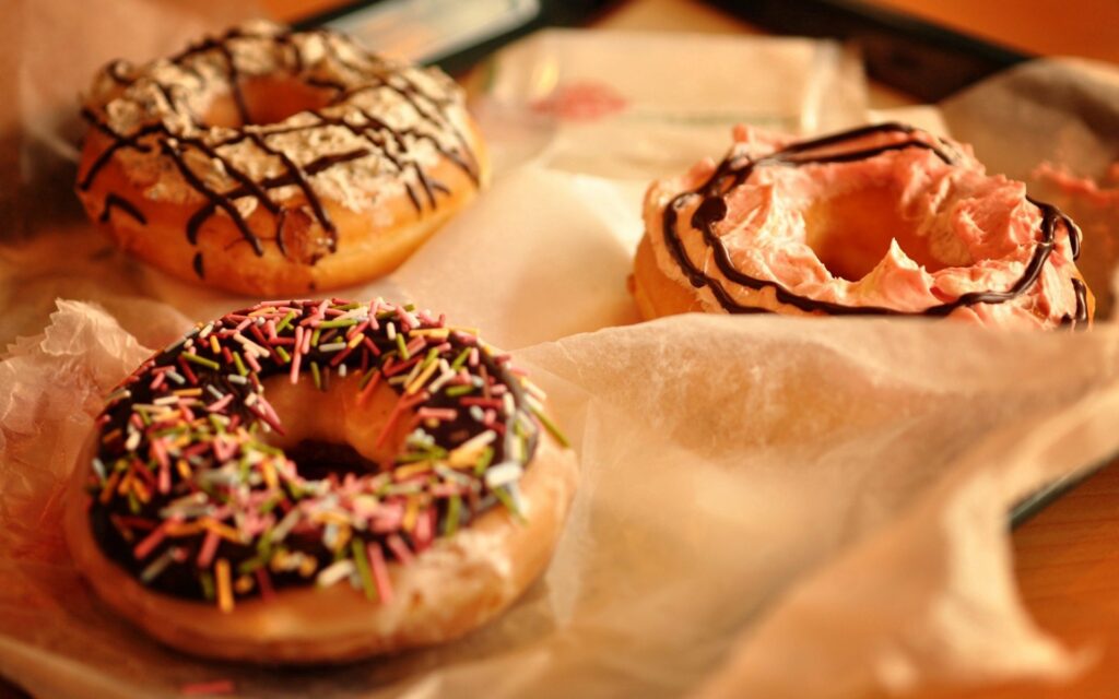Delicious Donuts with Sprinkles and Frosting - Wallpaper Background