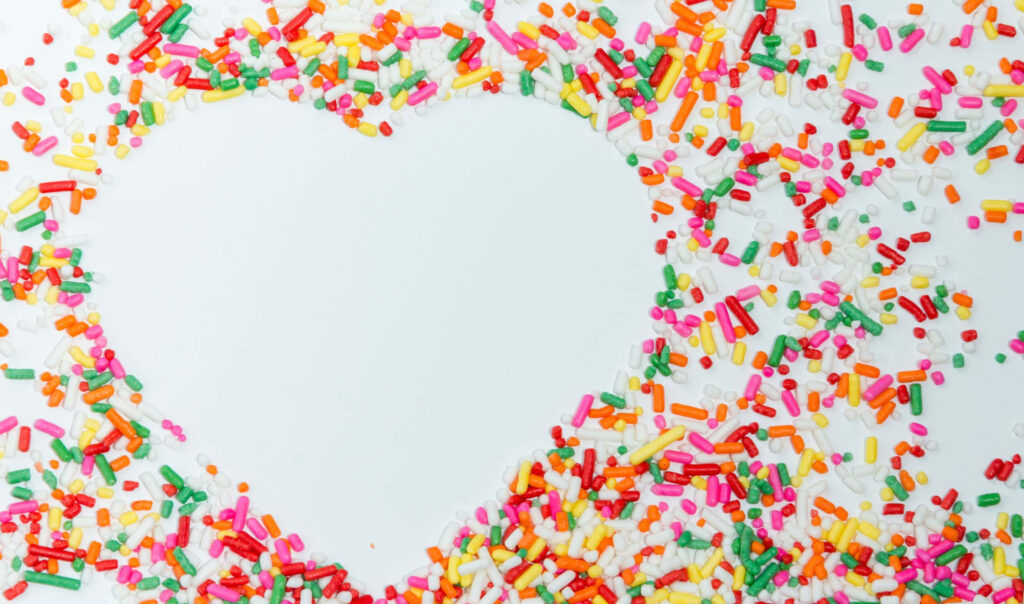 Cheerful Wallpaper: Colorful Sprinkles Around a Heart-Shaped Space