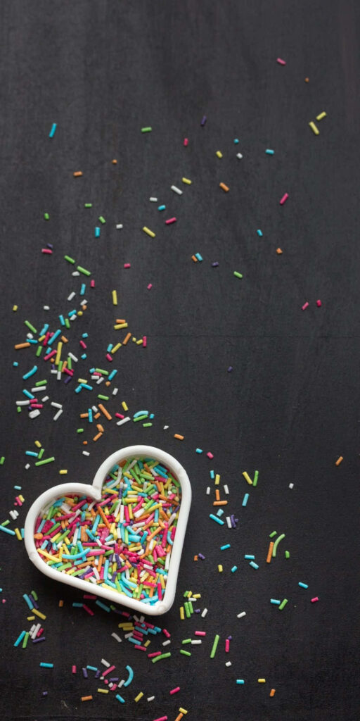 Colorful Sprinkle Heart Bowl on Blackboard Wallpaper Background