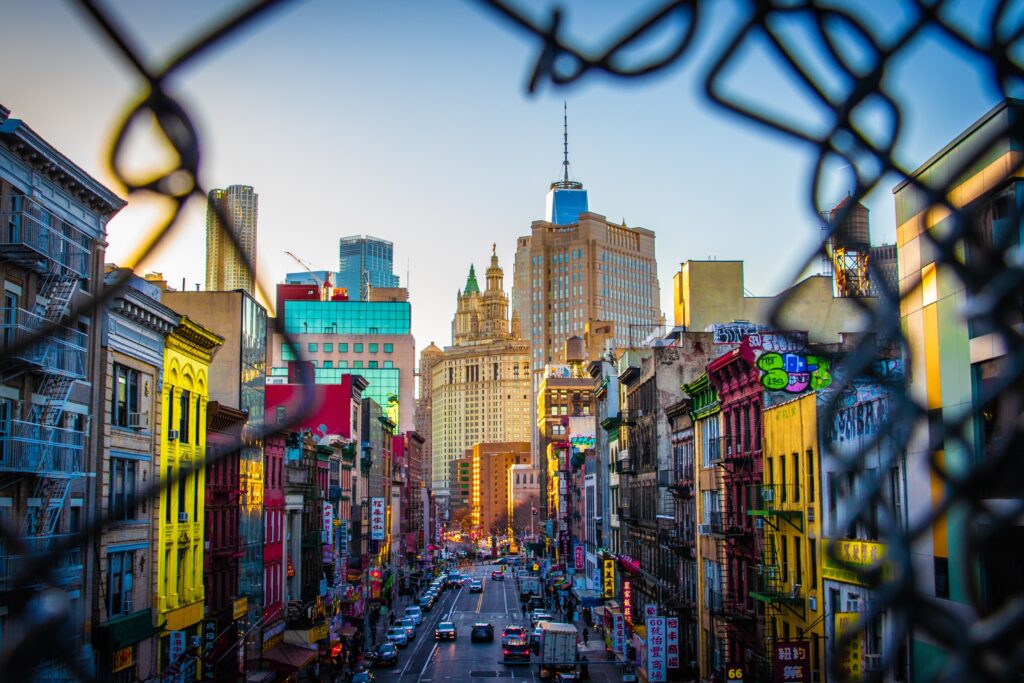 Vibrant Urban Wallpaper: City Street Through Chain-Link Fence