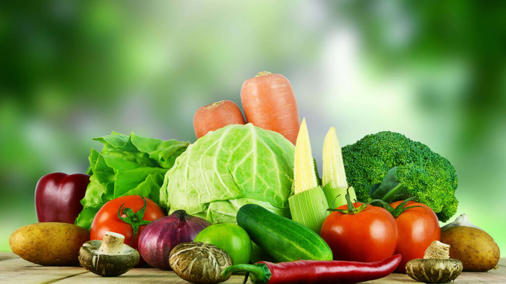 Vibrant Vegetable Wallpaper: Fresh Colors on a Blurred Green Background