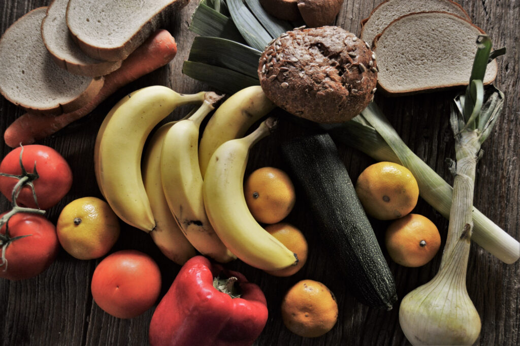 Vibrant Fruits and Vegetables Wallpaper on Rustic Wooden Surface