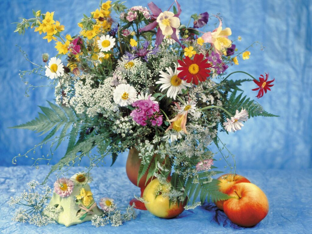 Vibrant Wildflower Bouquet with Apples Against Blue Background Wallpaper