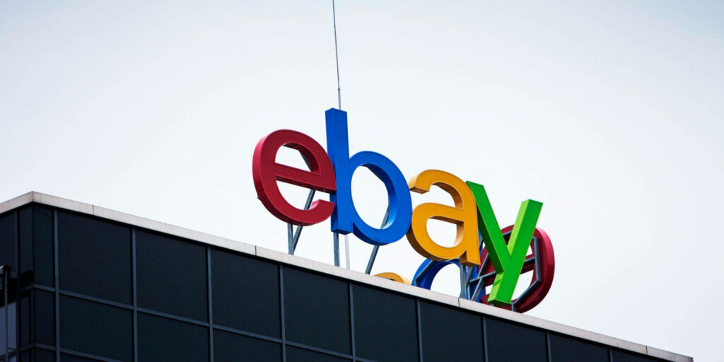 Colorful eBay logo on modern building under clear sky vibrant red blue yellow green branding wallpaper