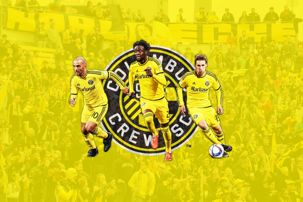 Columbus Crew wallpaper with three players in action on vibrant yellow background and team emblem