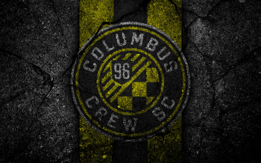 Columbus Crew logo on cracked dark background with vivid yellow black stripes wallpaper