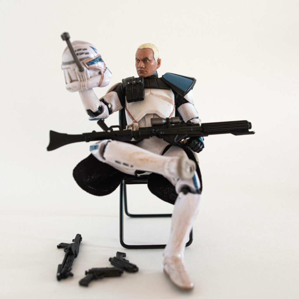 Commander Rex in white blue armor holding helmet and blaster Star Wars action figure wallpaper