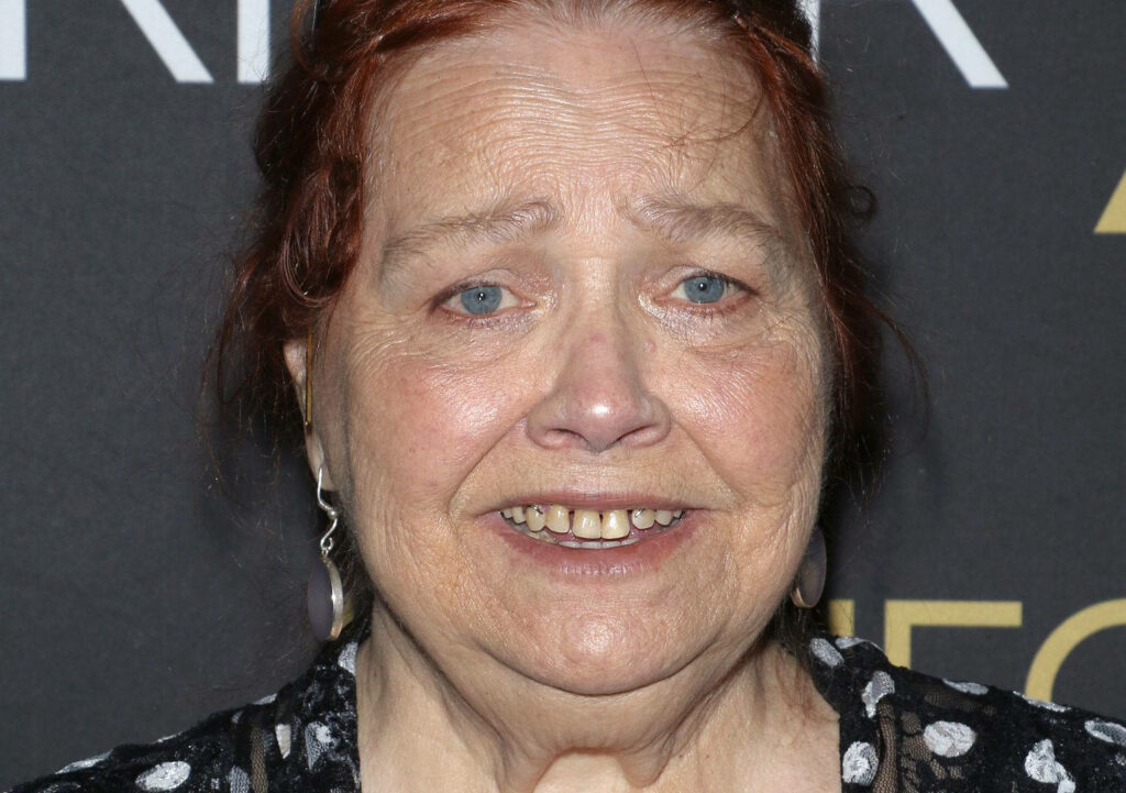 Close-up portrait of Conchata Ferrell with soft red hair light blue eyes and warm smile wallpaper