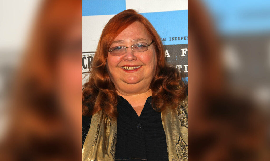 Conchata Ferrell smiling with glasses red hair blue white checkered background wallpaper
