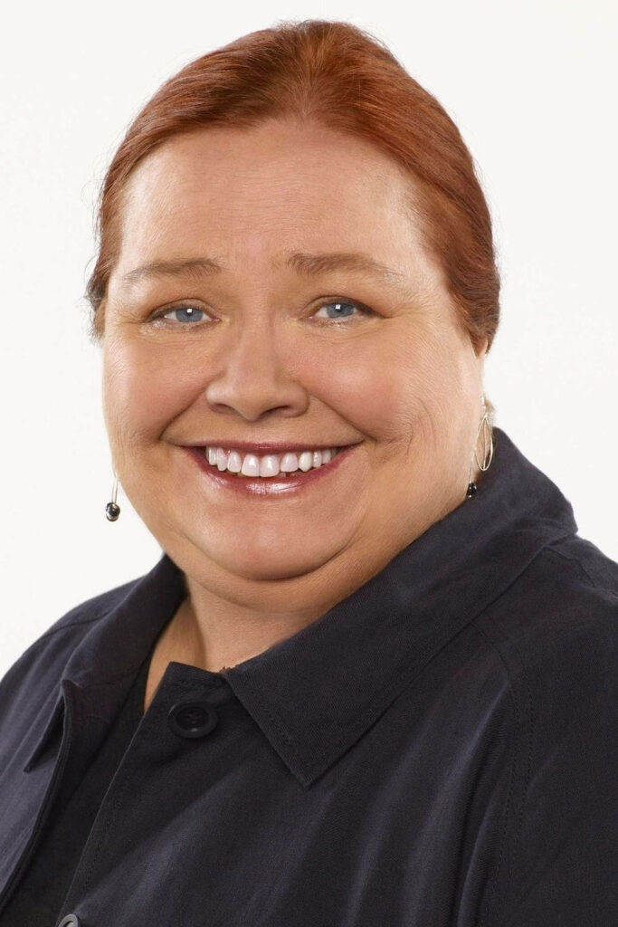Conchata Ferrell portrait with warm smile auburn hair studio photo wallpaper background