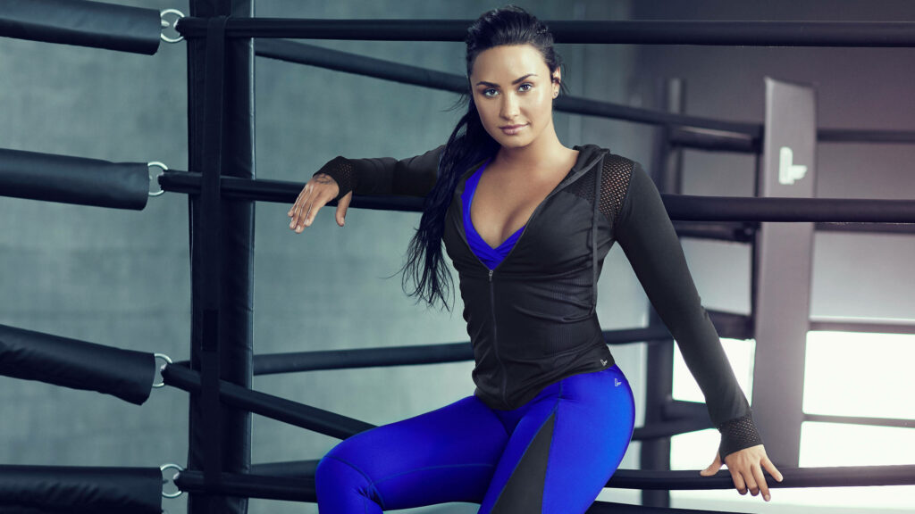 Demi Lovato Wallpaper: Sporty Confident Pose in Vibrant Athletic Wear