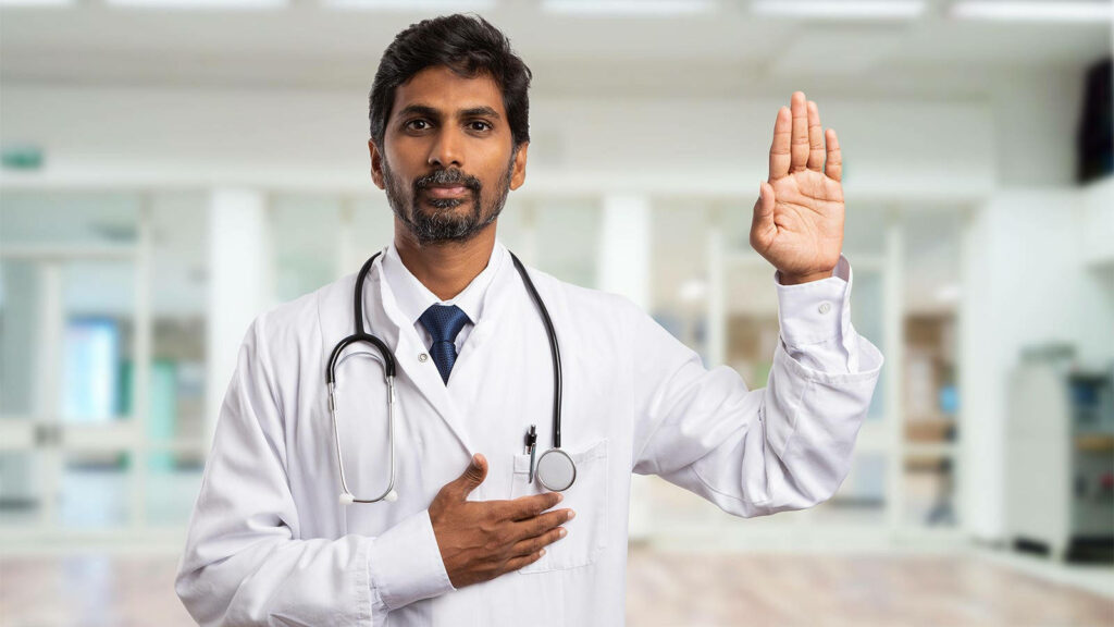Confident doctor in white coat raising hand in hospital symbolizing trust and professionalism Wallpaper