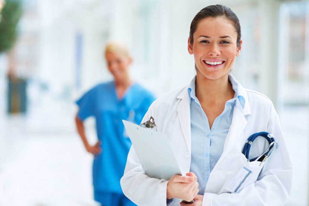 Confident female doctor with stethoscope and clipboard in modern bright medical setting wallpaper