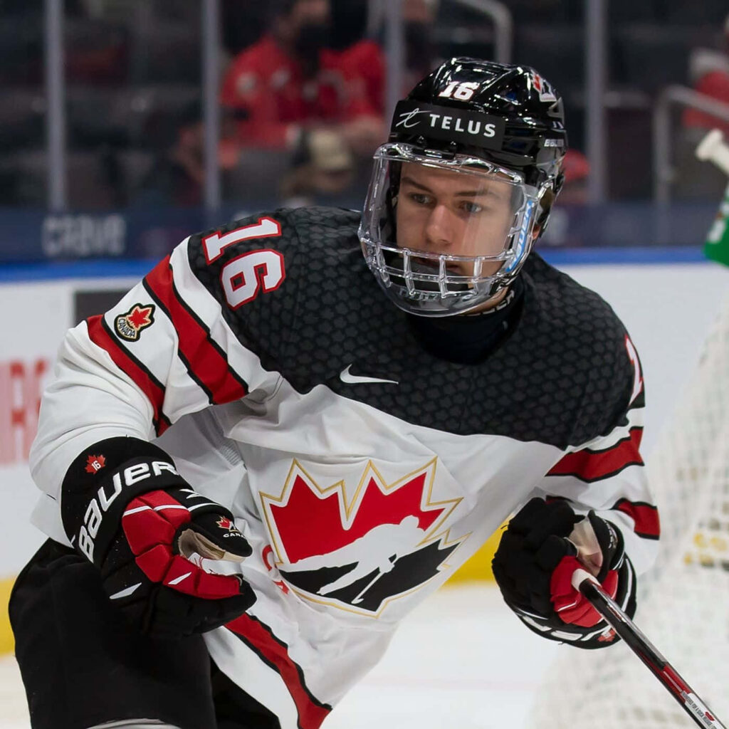 Connor Bedard in Team Canada jersey intense focus high resolution hockey action on ice rink background Wallpaper