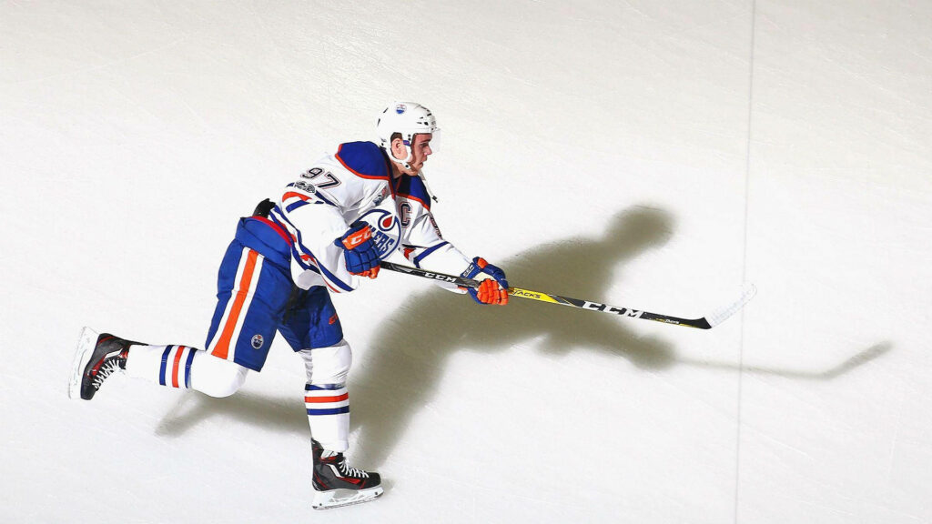 Connor McDavid Edmonton Oilers ice hockey player action shot bright arena lighting wallpaper