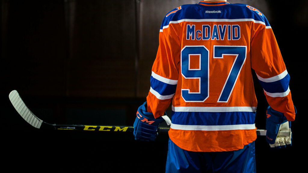 Connor McDavid Edmonton Oilers number 97 jersey back view with hockey stick vibrant wallpaper