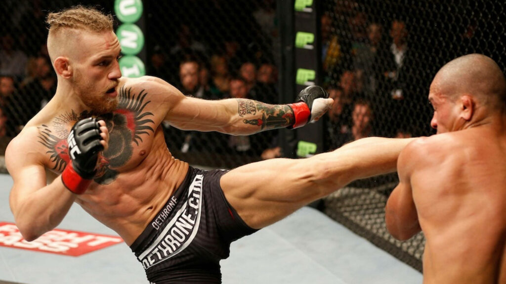 Conor McGregor's Epic High Kick: Intense MMA Wallpaper Background