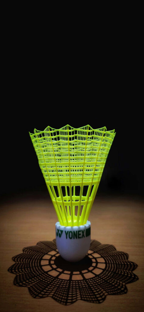 Yellow Badminton Shuttlecock in Dark Background Wallpaper
