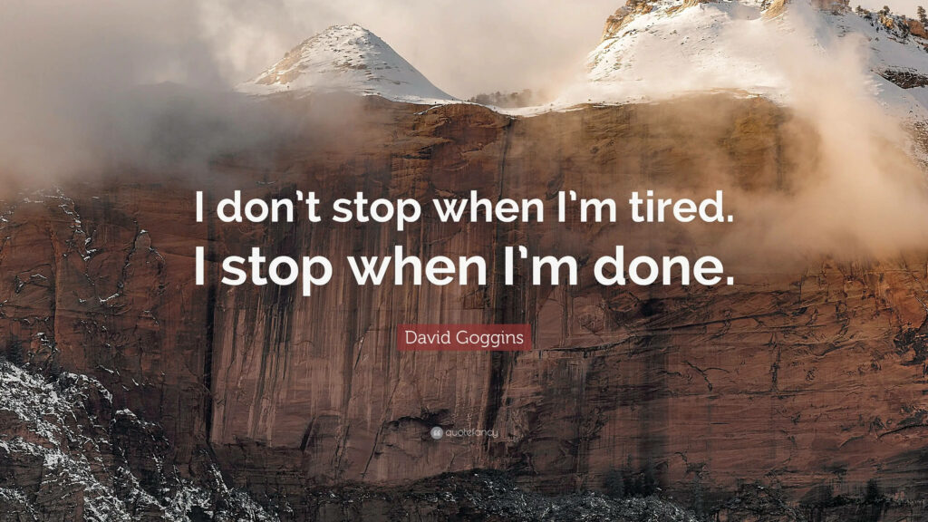 Motivational wallpaper with snow-dusted mountain and David Goggins inspiring quote for focus