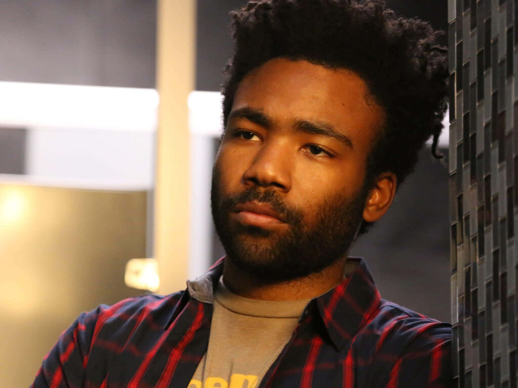 Contemplative Donald Glover: Warm Indoor Wallpaper Background