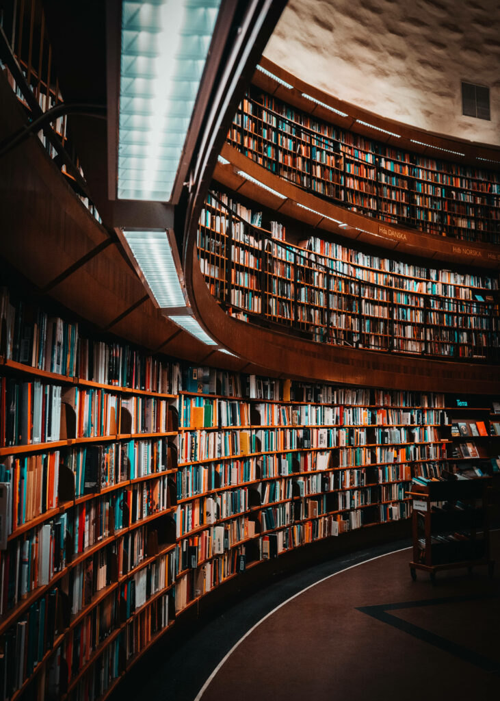 Contemporary library with curved colorful shelves and modern lighting creating inviting atmosphere Wallpaper