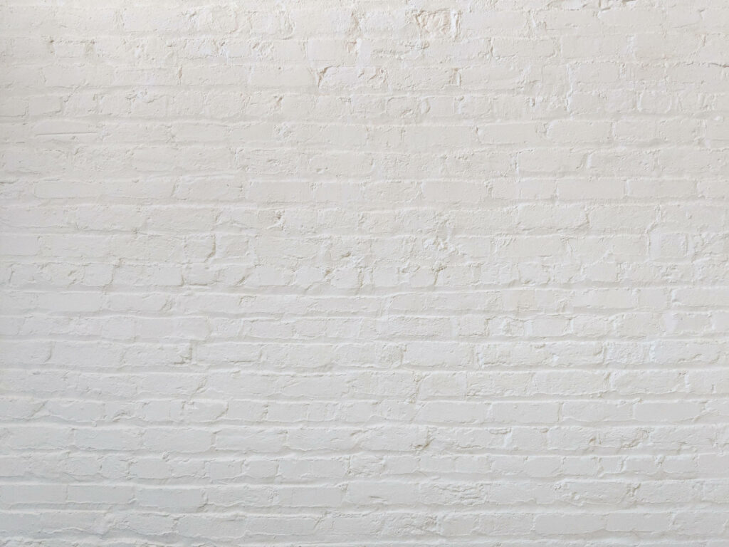 Contrasting Elegance: Graceful Brick Wall Enhanced by Clean White Finish Wallpaper
