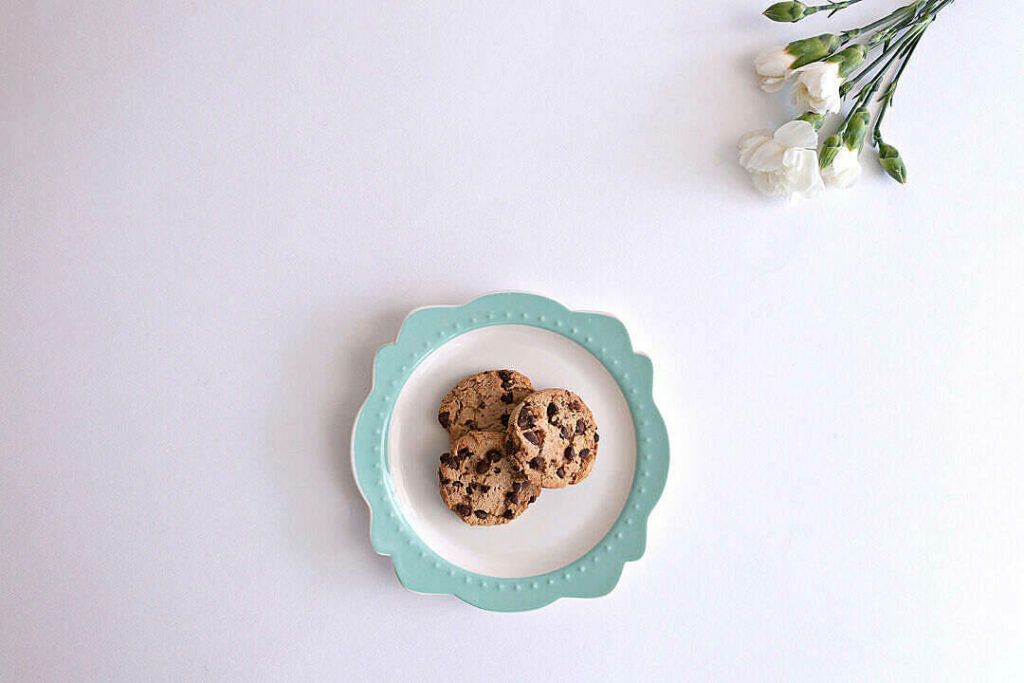 Cookie Temptation: Exquisite Chocolate Chip Delight Blooms in Serene Minimalist Setting Wallpaper