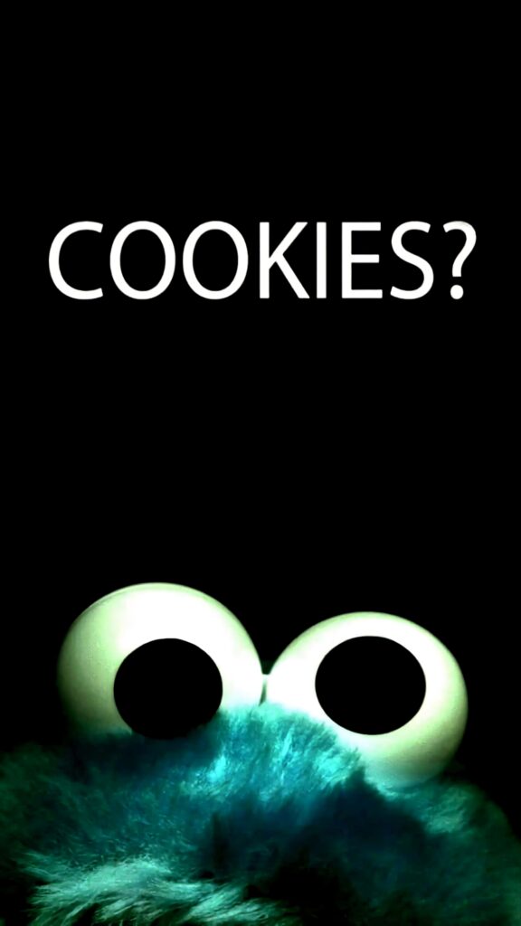 Cookie Monster peeking from bottom on black background with bold white COOKIES text wallpaper