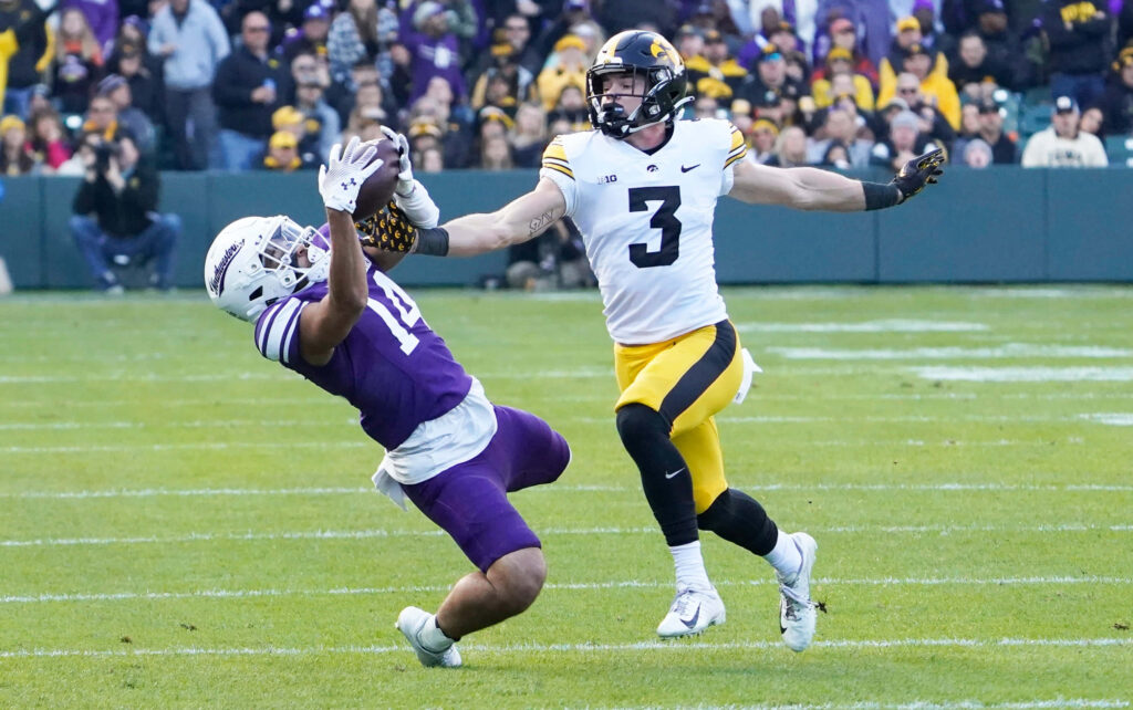 Cooper DeJean Iowa Hawkeyes football intense chase action high resolution dynamic sports wallpaper
