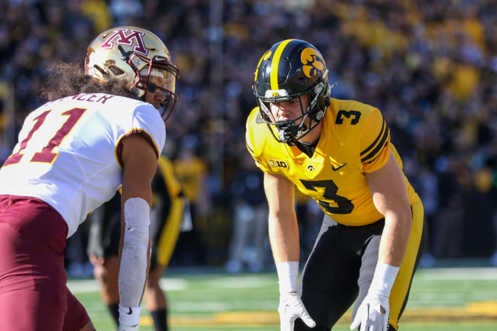 Cooper DeJean Iowa Hawkeyes defensive back in yellow black uniform vs Minnesota Golden Gophers Wallpaper
