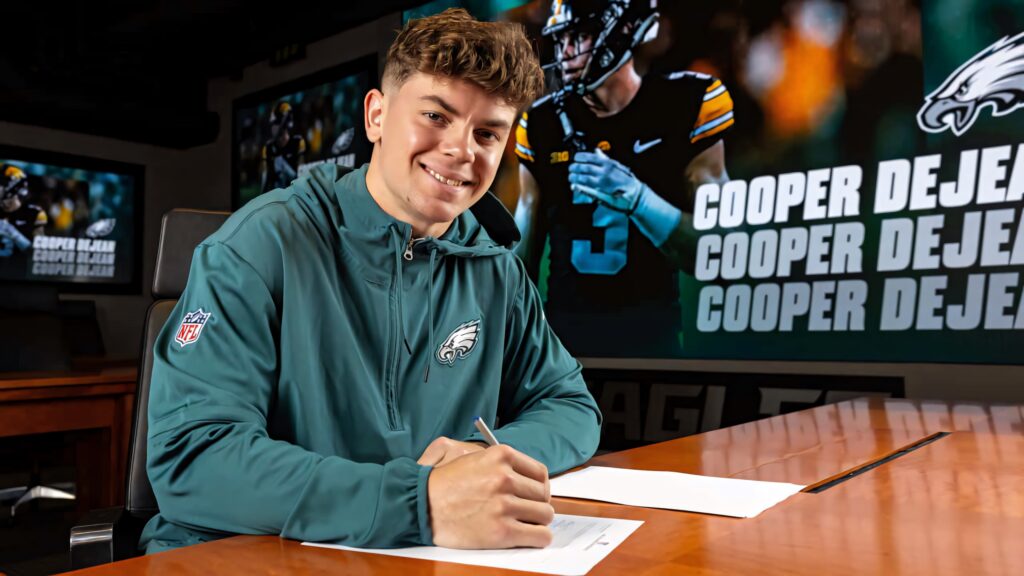 Cooper DeJean Philadelphia Eagles signing wallpaper vibrant sports action dynamic backdrop