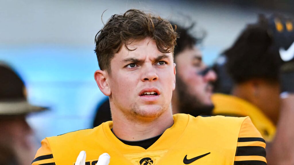 Cooper DeJean in yellow and black football uniform focused with natural lighting wallpaper background