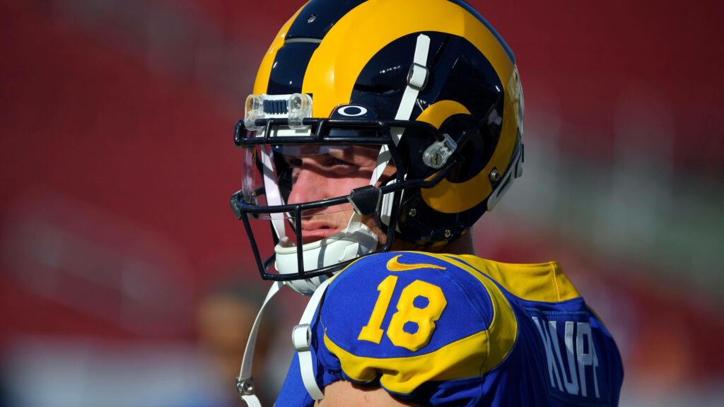 Cooper Kupp focused on field in Rams uniform helmet intense NFL football action wallpaper background