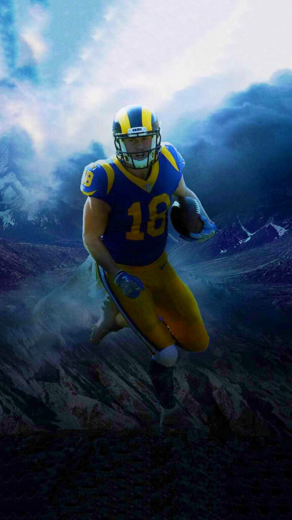 Cooper Kupp running with football in LA Rams uniform against dramatic mountain landscape background Wallpaper