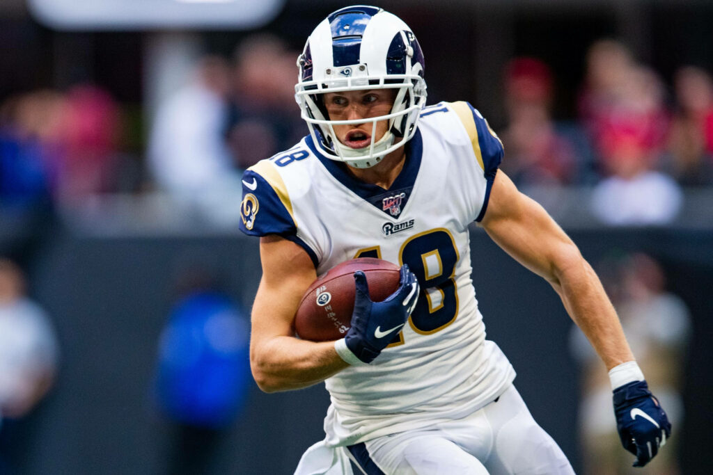Cooper Kupp running on field showing athleticism for Los Angeles Rams NFL game wallpaper background