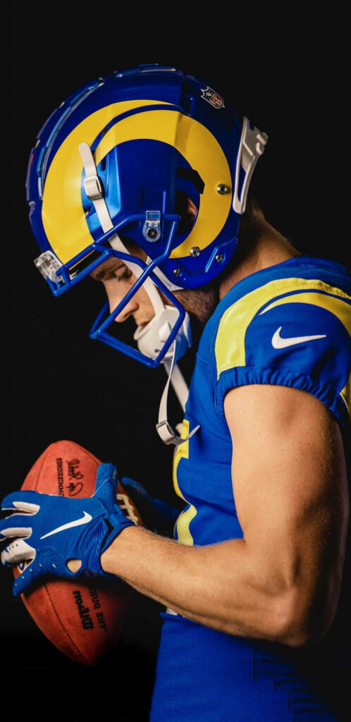 Cooper Kupp Los Angeles Rams NFL player focused in team uniform holding football professional photo Wallpaper