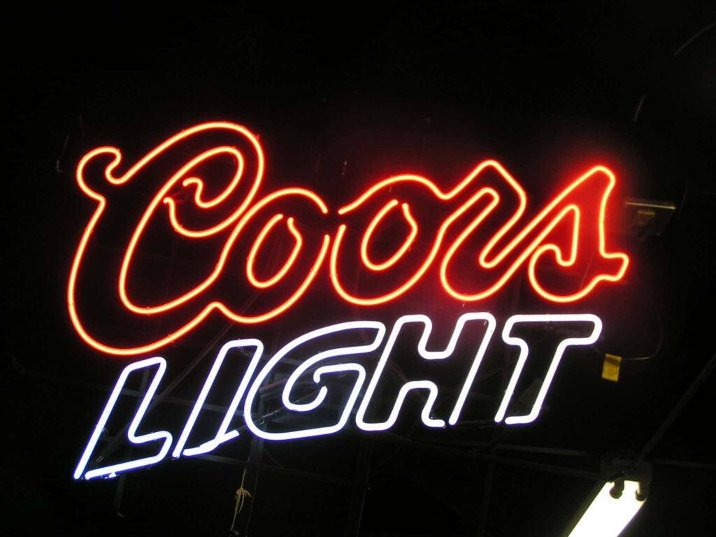 Coors Light neon sign glowing bright red and white on dark background vibrant bar style wallpaper