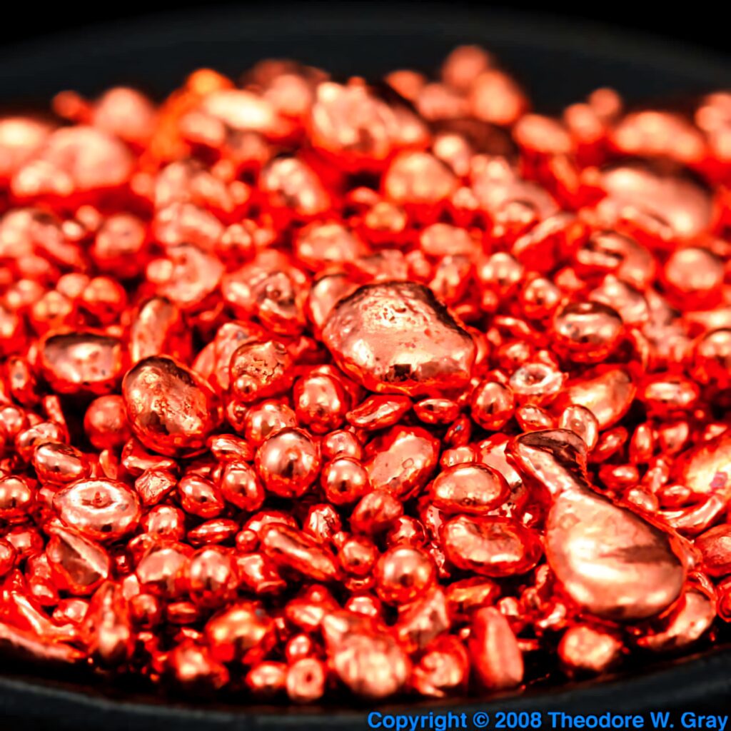 Close-up of rich metallic copper nuggets wallpaper with shiny reflective texture background