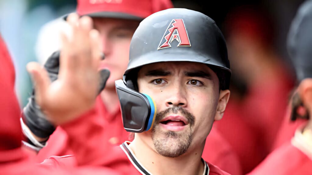 Corbin Carroll Arizona Diamondbacks celebrating with teammates vibrant red baseball intensity Wallpaper
