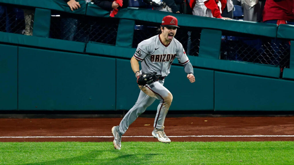 Corbin Carroll in Arizona Diamondbacks uniform energized mid-action with vibrant stadium lights Wallpaper