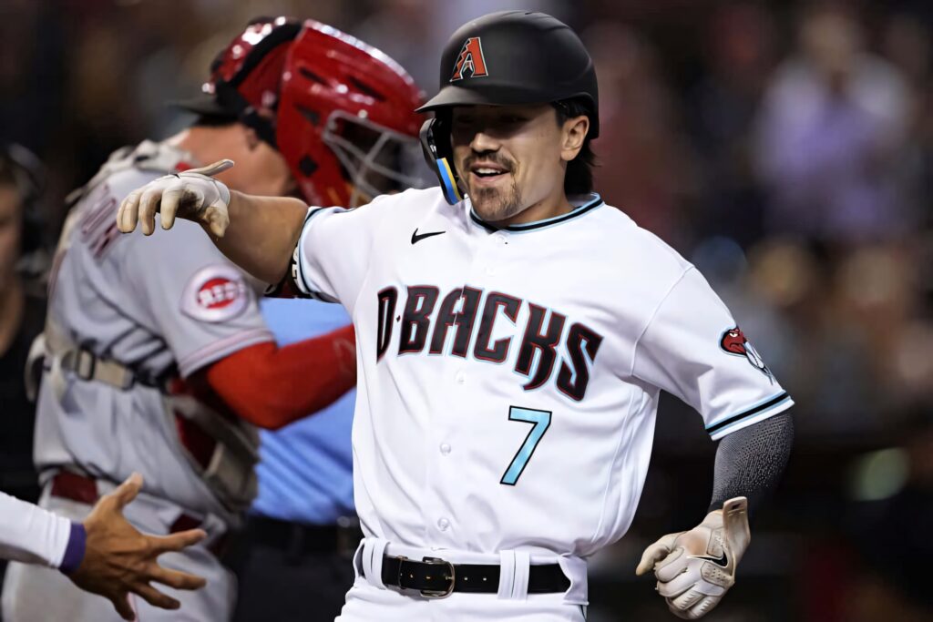 Corbin Carroll Arizona Diamondbacks number 7 celebrating on field under stadium lights vibrant action Wallpaper