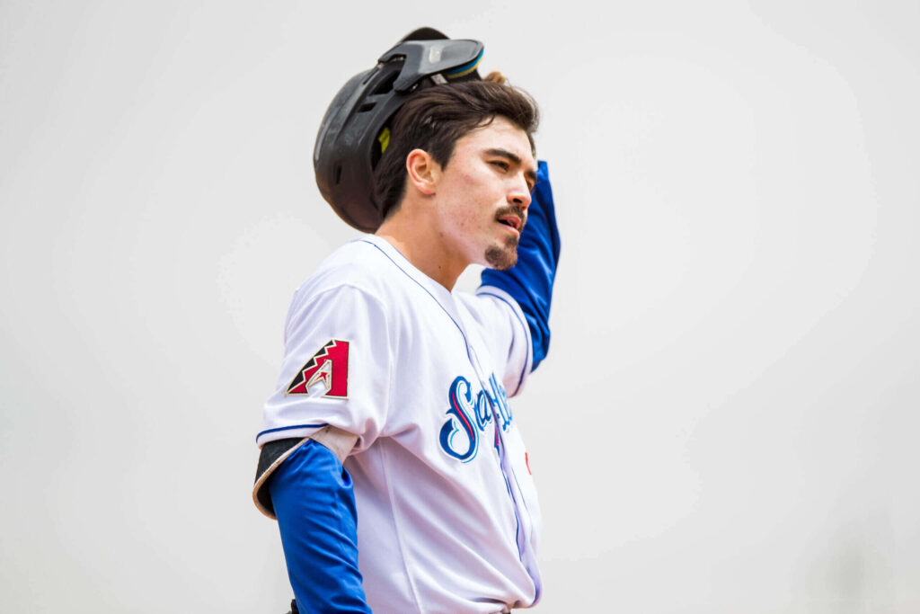 Corbin Carroll Arizona Diamondbacks baseball player in white jersey focused on the field game intensity Wallpaper