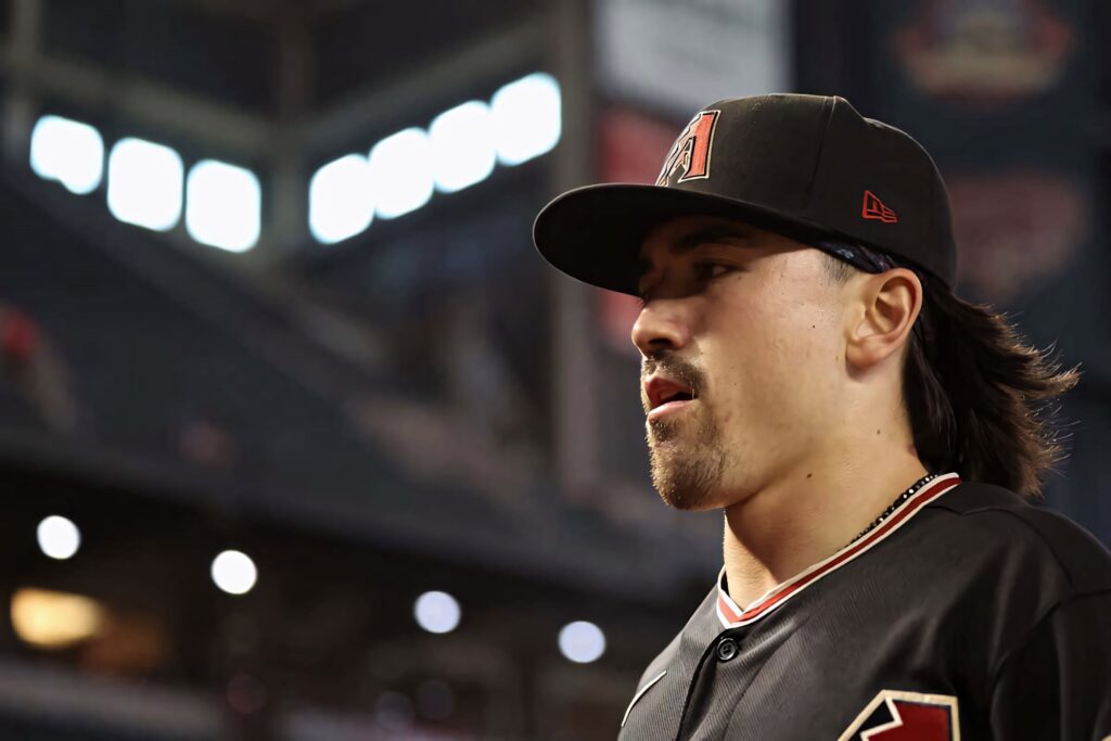 Corbin Carroll in black Arizona Diamondbacks uniform focused in dynamic stadium baseball wallpaper